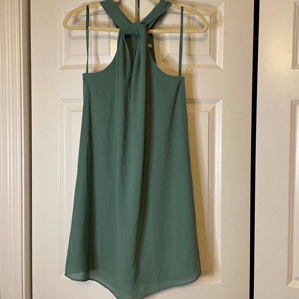 Size medium, naked zebra, halter teal dress with key holes in front and back.